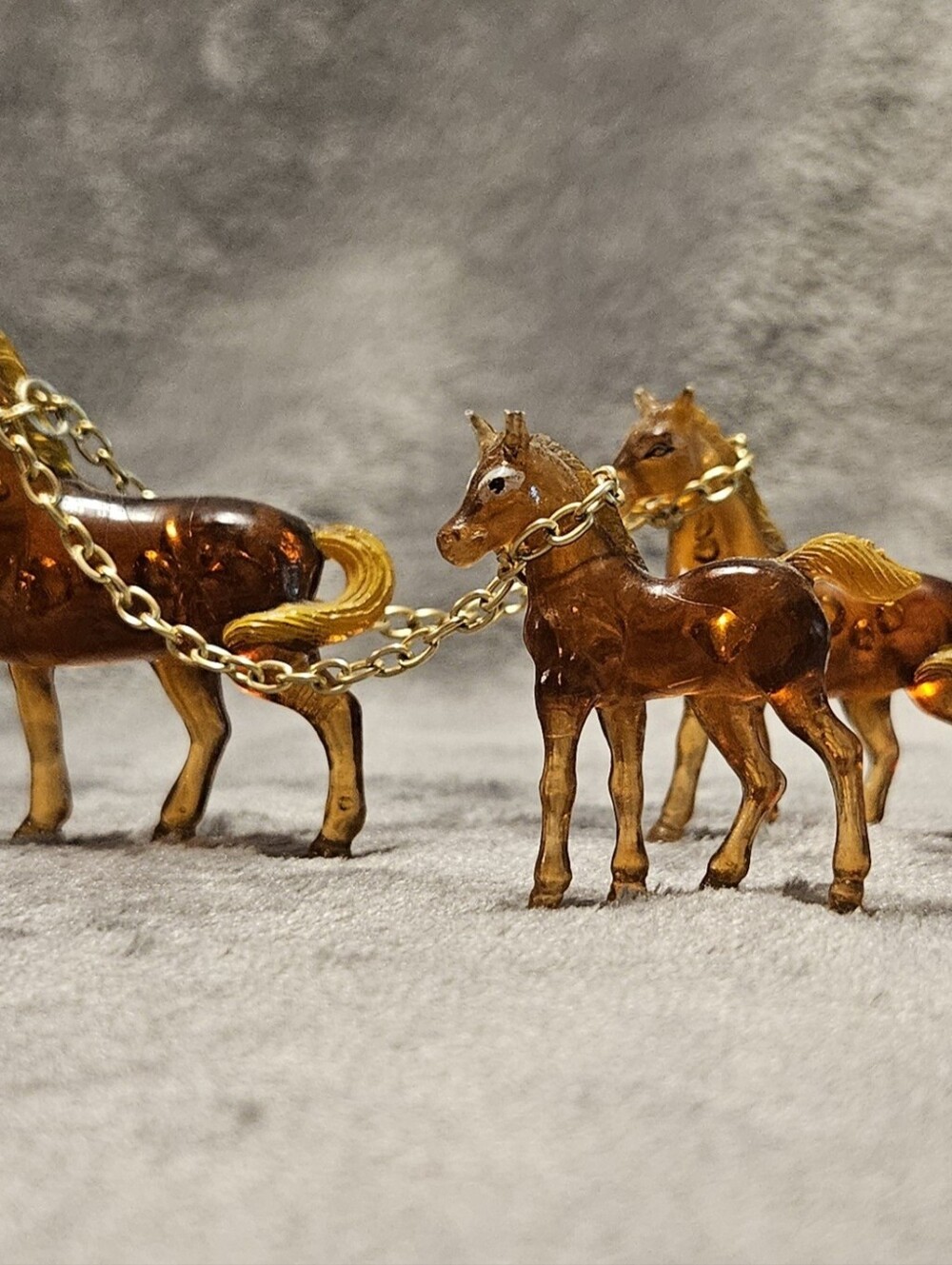 70s Vintage amber plastic horse trio with gold accents and chain.